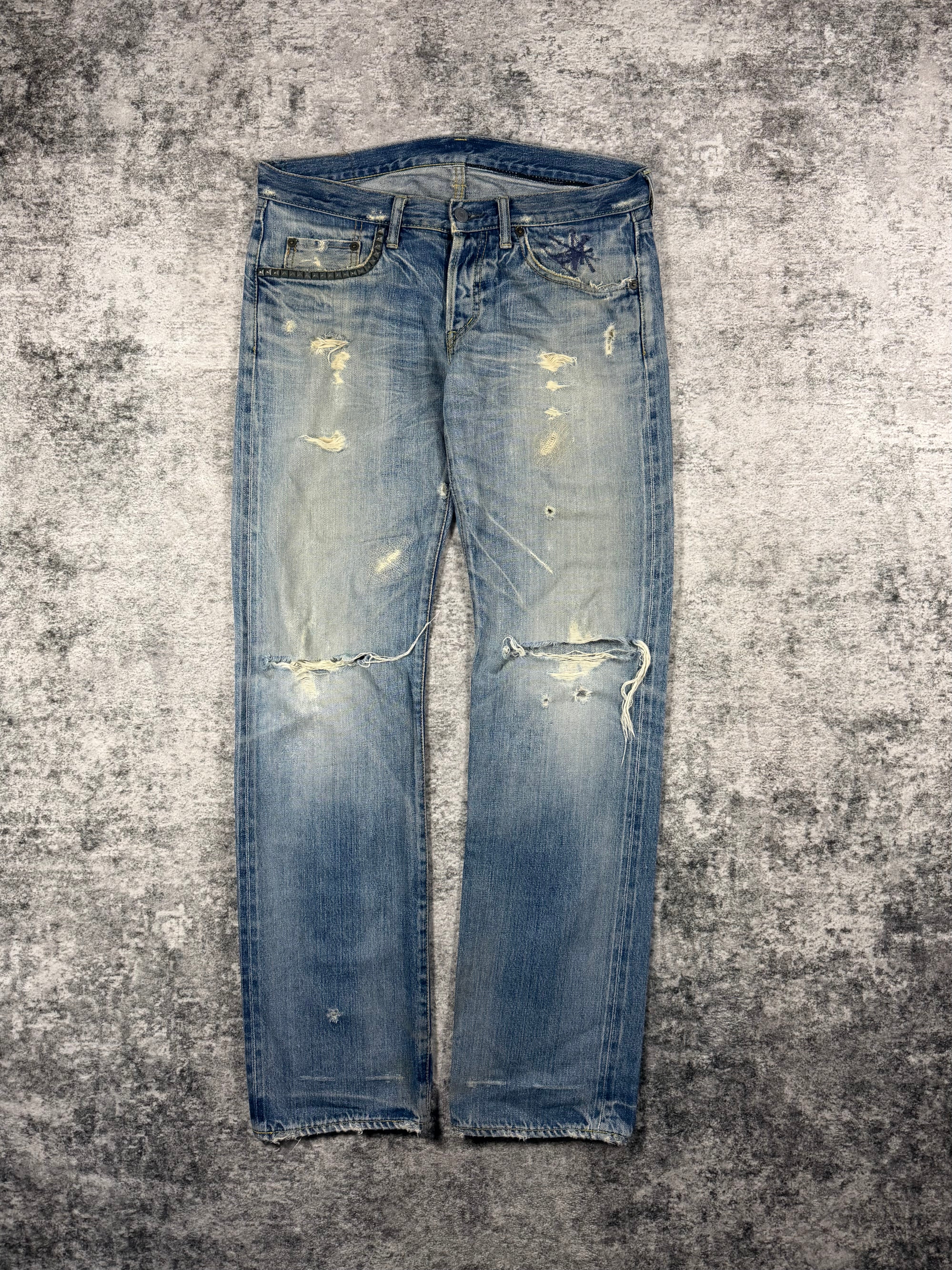 Front view of Hysteric Glamour light wash crash denim jeans with heavy distressing