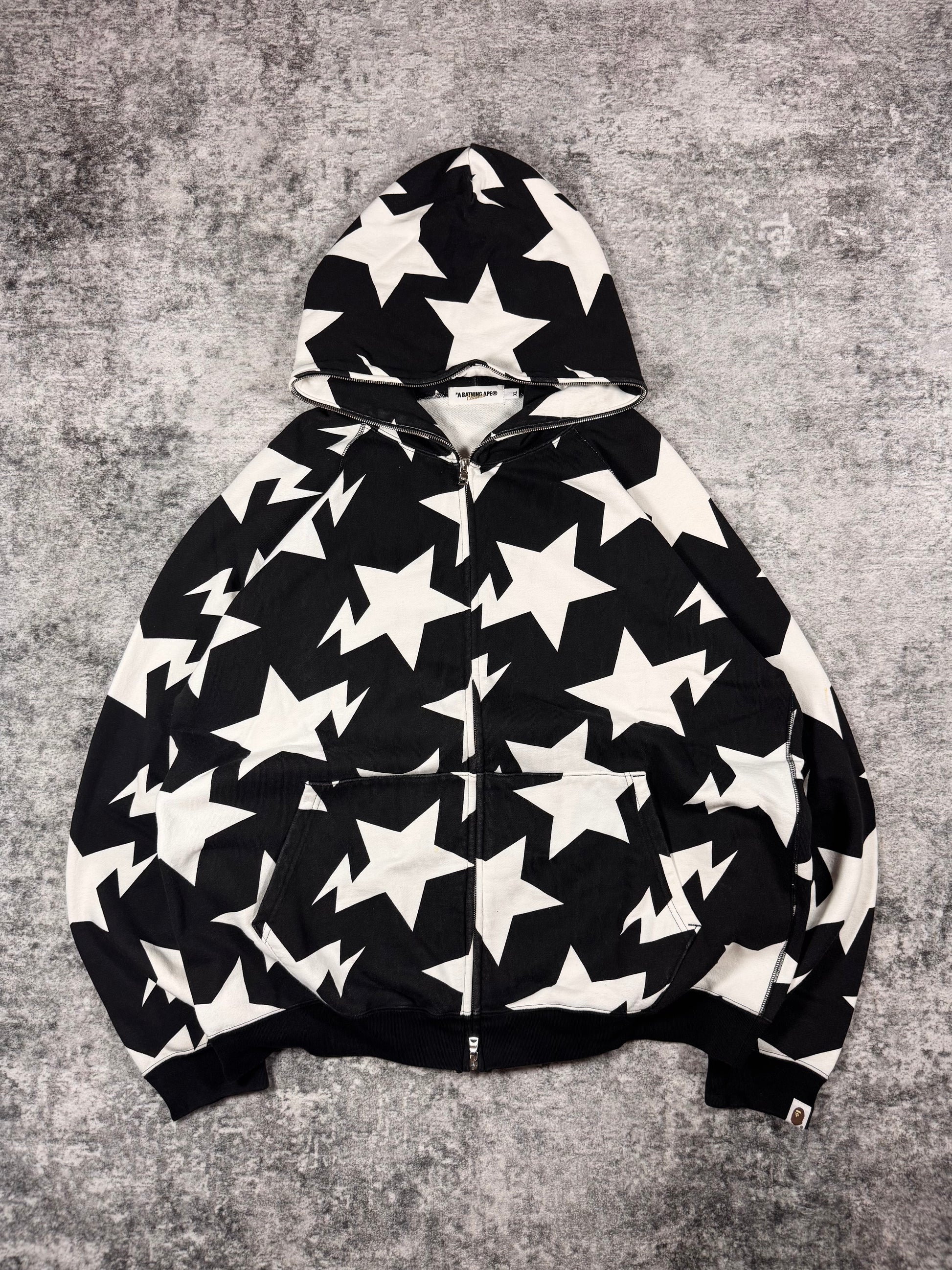Mid-2000s BAPE Classics black and white star print full-zip hoodie laid flat, made in Japan