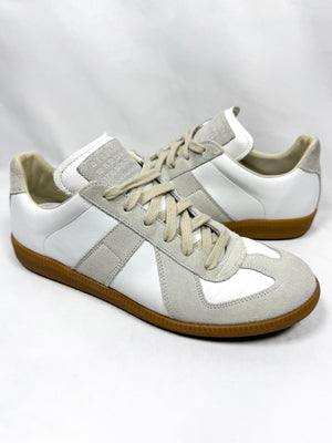Pair of white and gray Maison Margiela German army trainers with brown soles on a white background