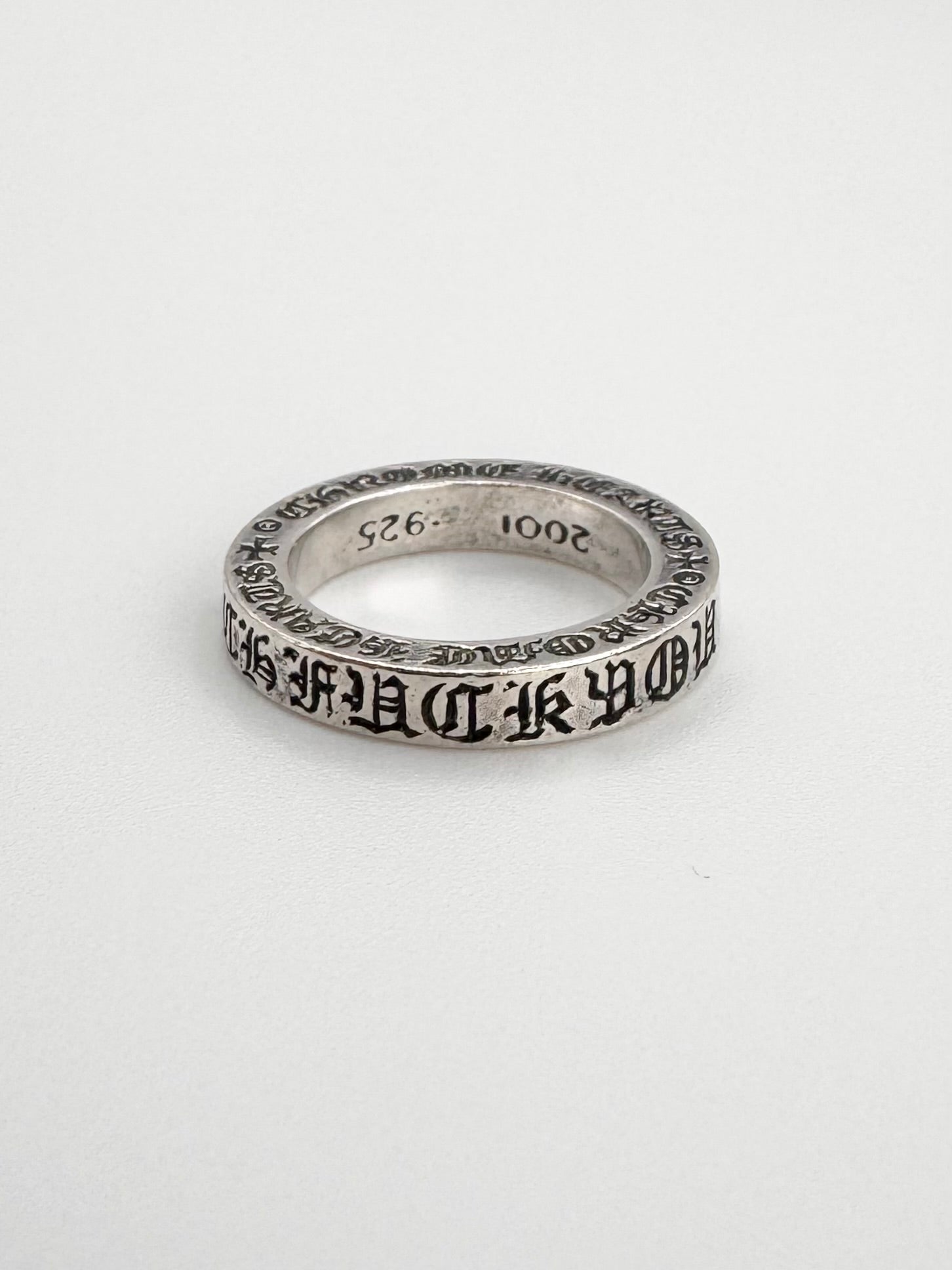 Classic chrome hearts ring in silver with the ‘fuck you’ embroidery along with signature cross motifs on a 3 mm spacer ring.