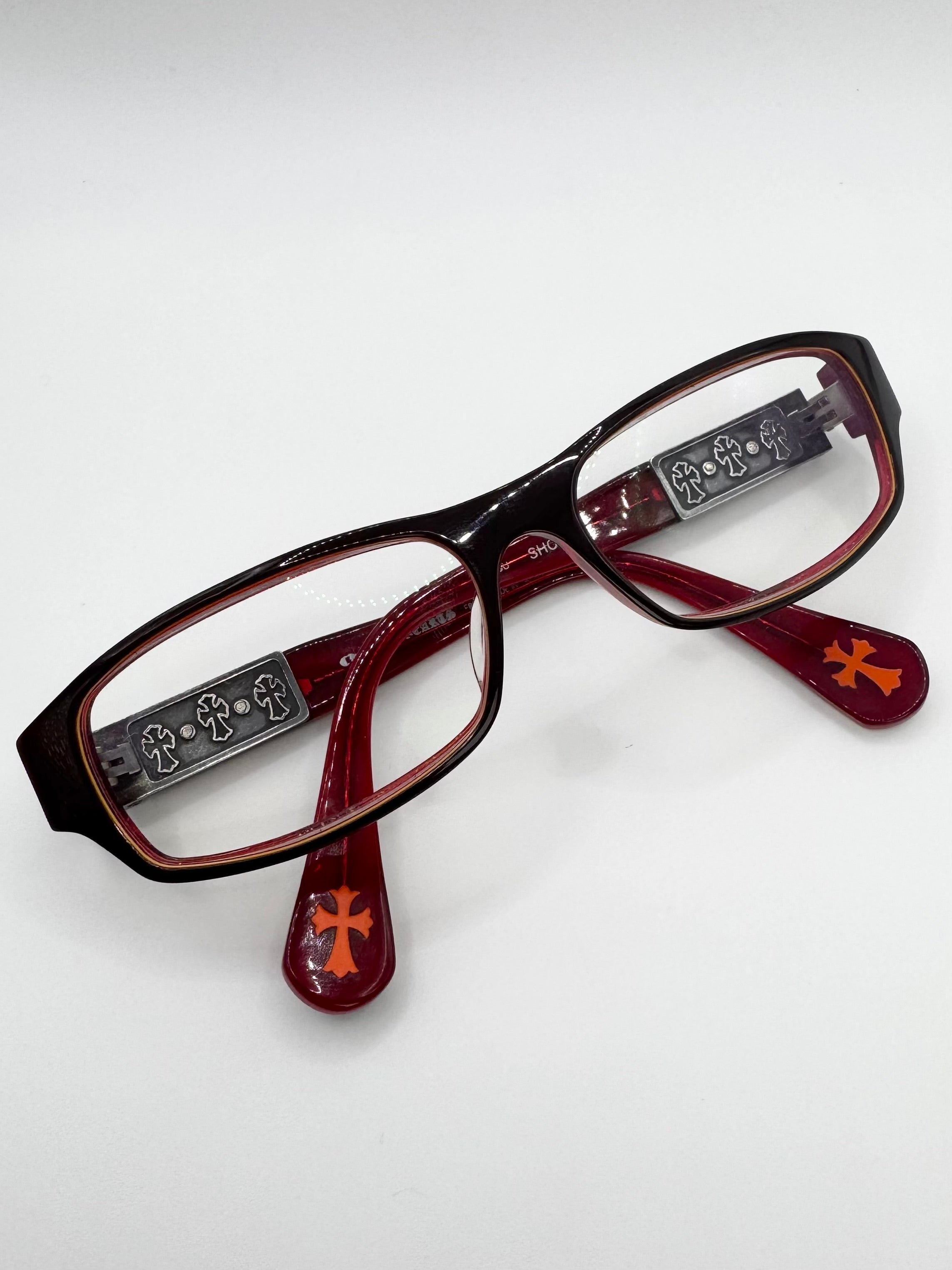 Chrome Hearts ‘Shooter’ Smoke Green Cemetery Cross Glass Frames with decorative arms on a white background