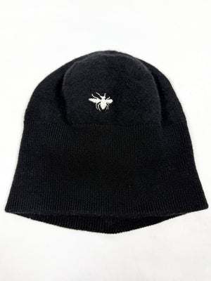 Black Dior Homme These Grey Days Bee Embroidery Beanie with a white bee logo on the ground laid on a white background