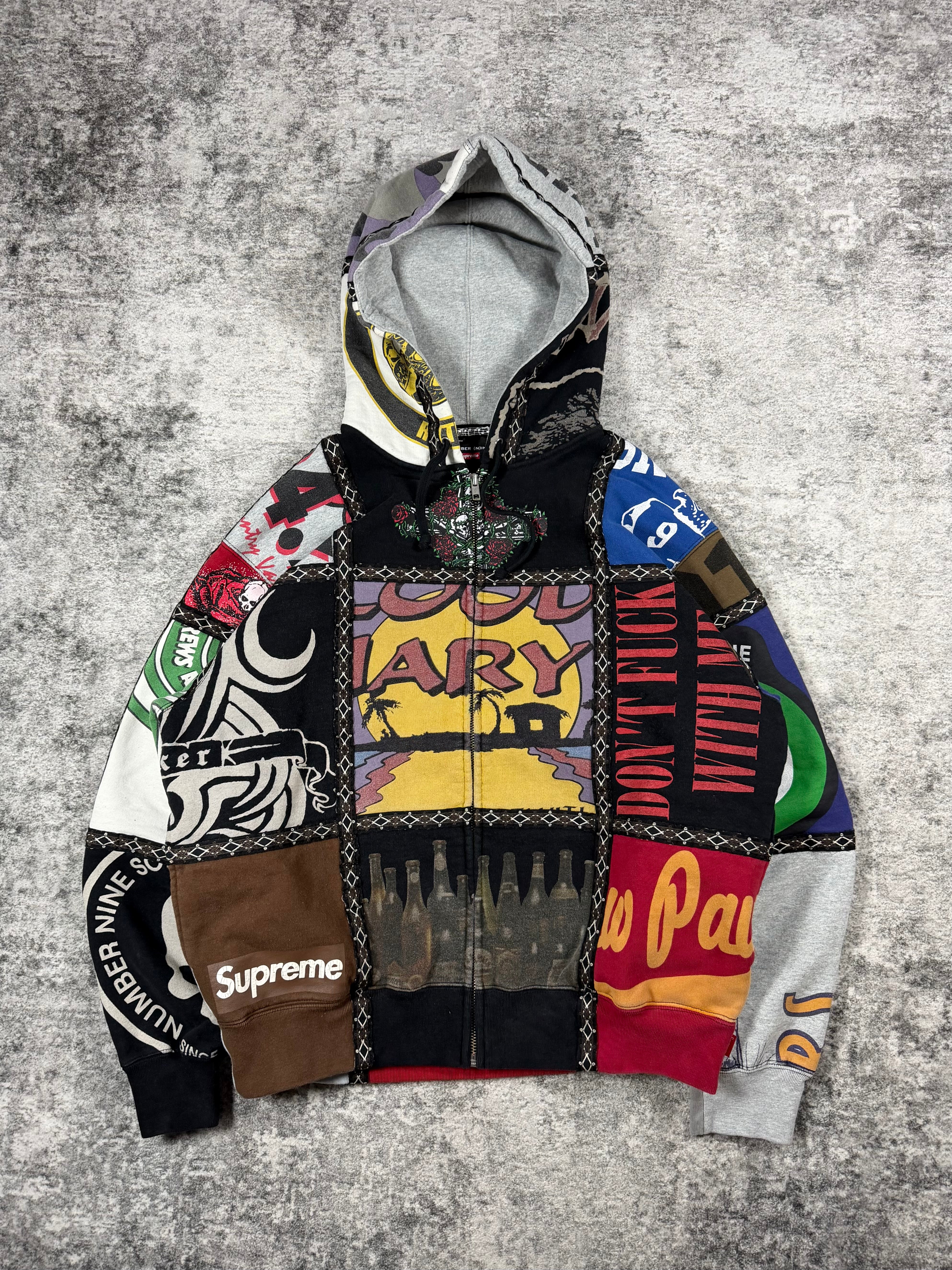 FW25 Number (N)ine x Supreme patchwork zip-up hoodie featuring reconstructed multi-panel graphic fleece construction with assorted logos, skull motifs, typography prints, contrast stitched trim, full zip closure, and hood.