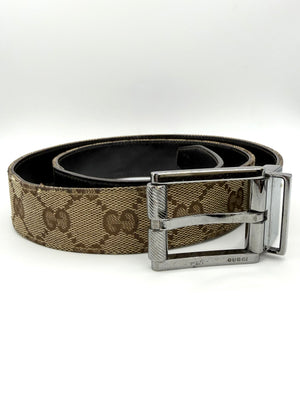 Beige Gucci belt with silver buckle on a white background