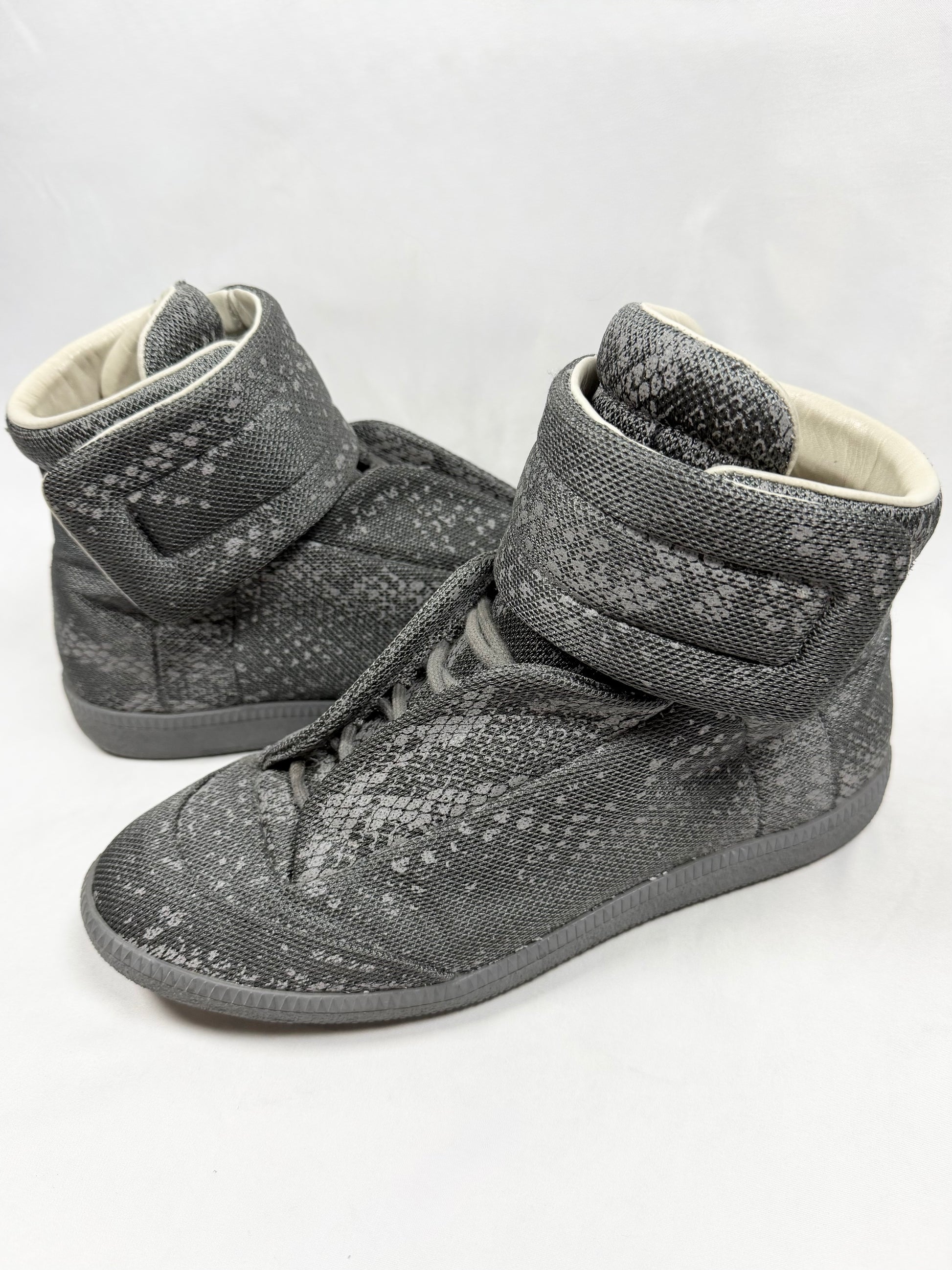Maison Margiela Reflective Python Future High grey 3M sneakers with velcro strap and textured reptile pattern shown in studio lighting
