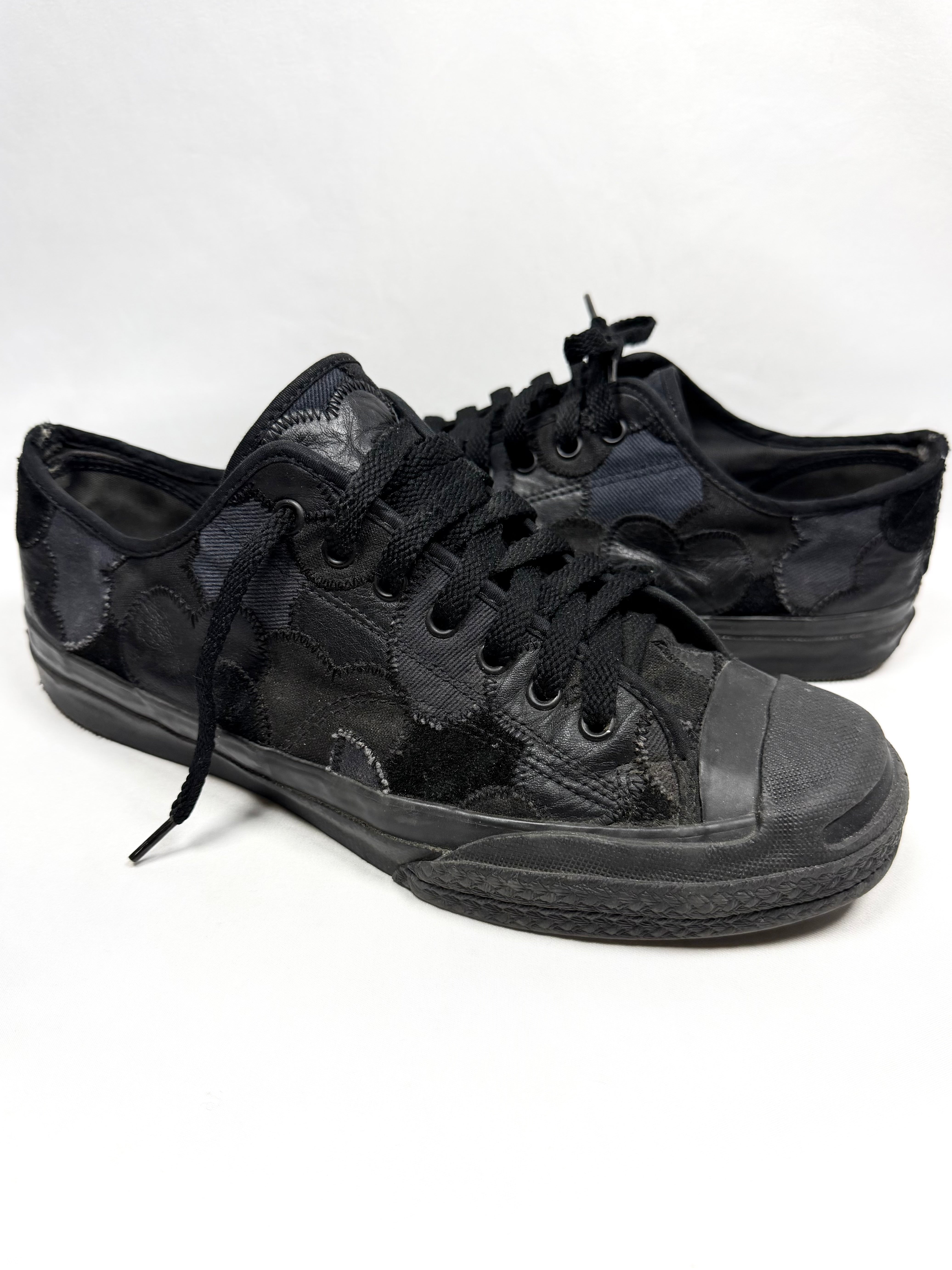 Number (N)ine black patchwork sneakers with tonal laces and rubber toe caps