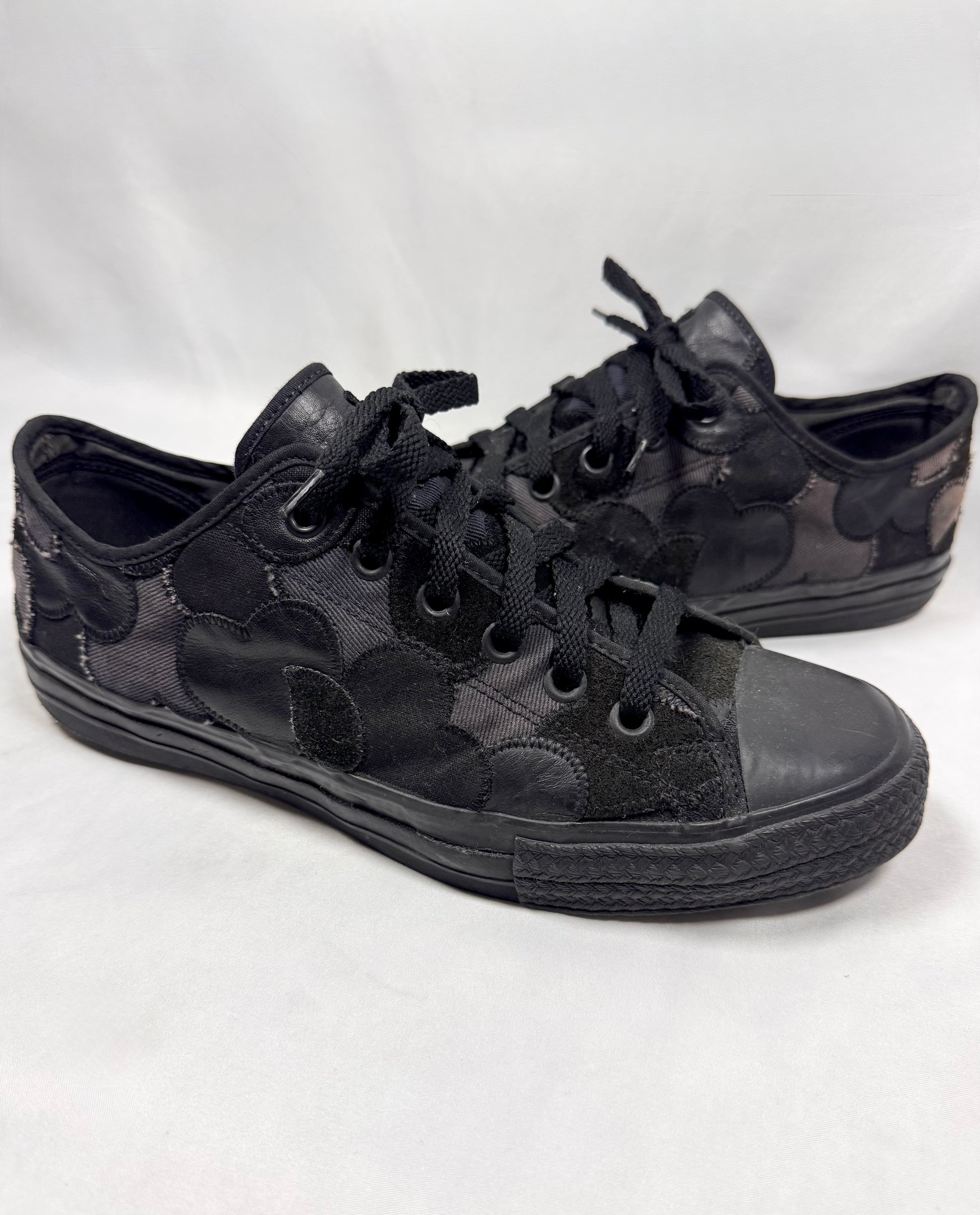 Number (N)ine Takahiro Miyashita crying heart patchwork sneakers side profile on white background. 