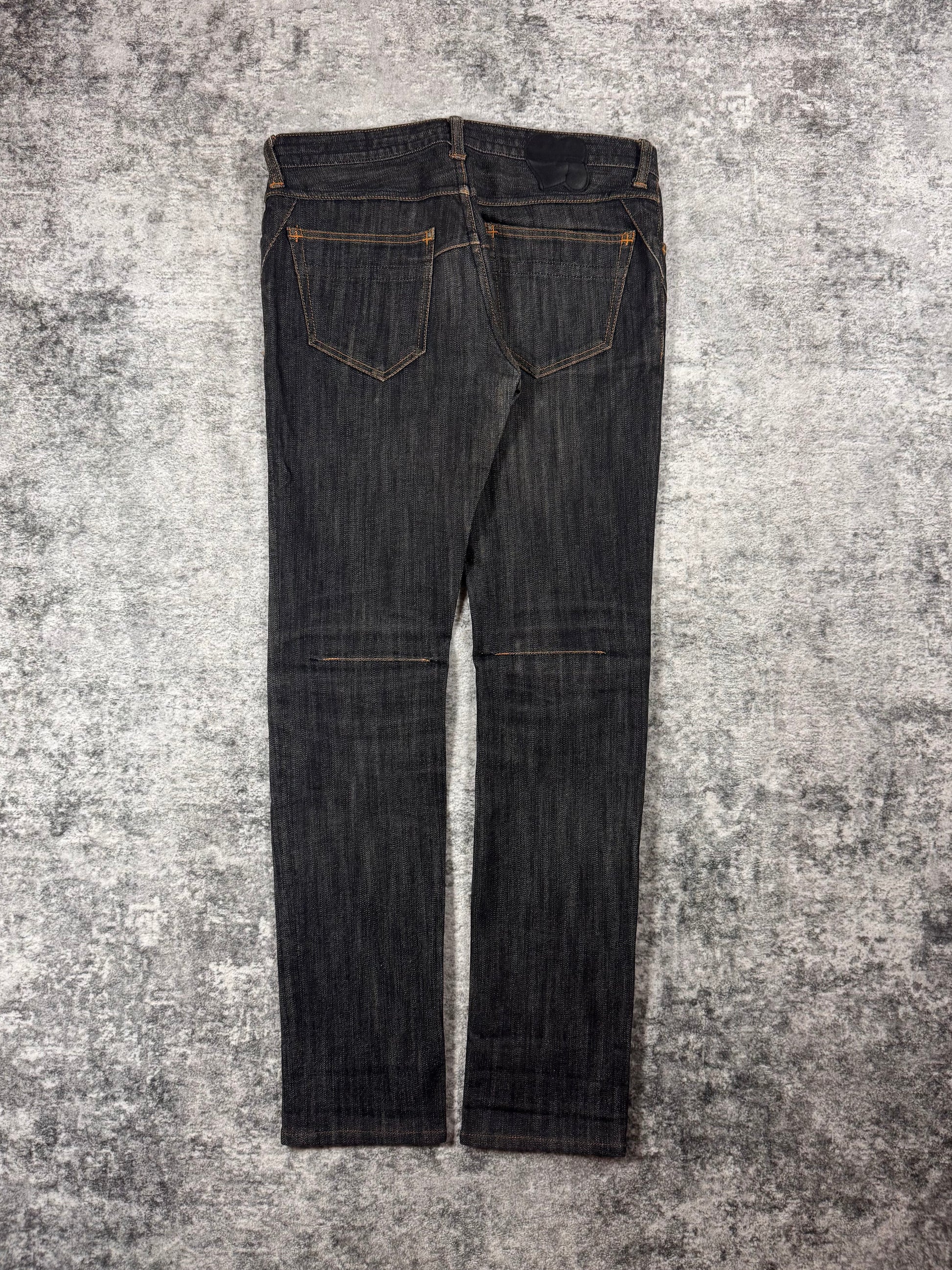 Number (N)ine raw denim from the Fall/Winter 2007 collection coming in a charcoal wash with intricate stitching details and signature crying heart patch showcased on grey background. 