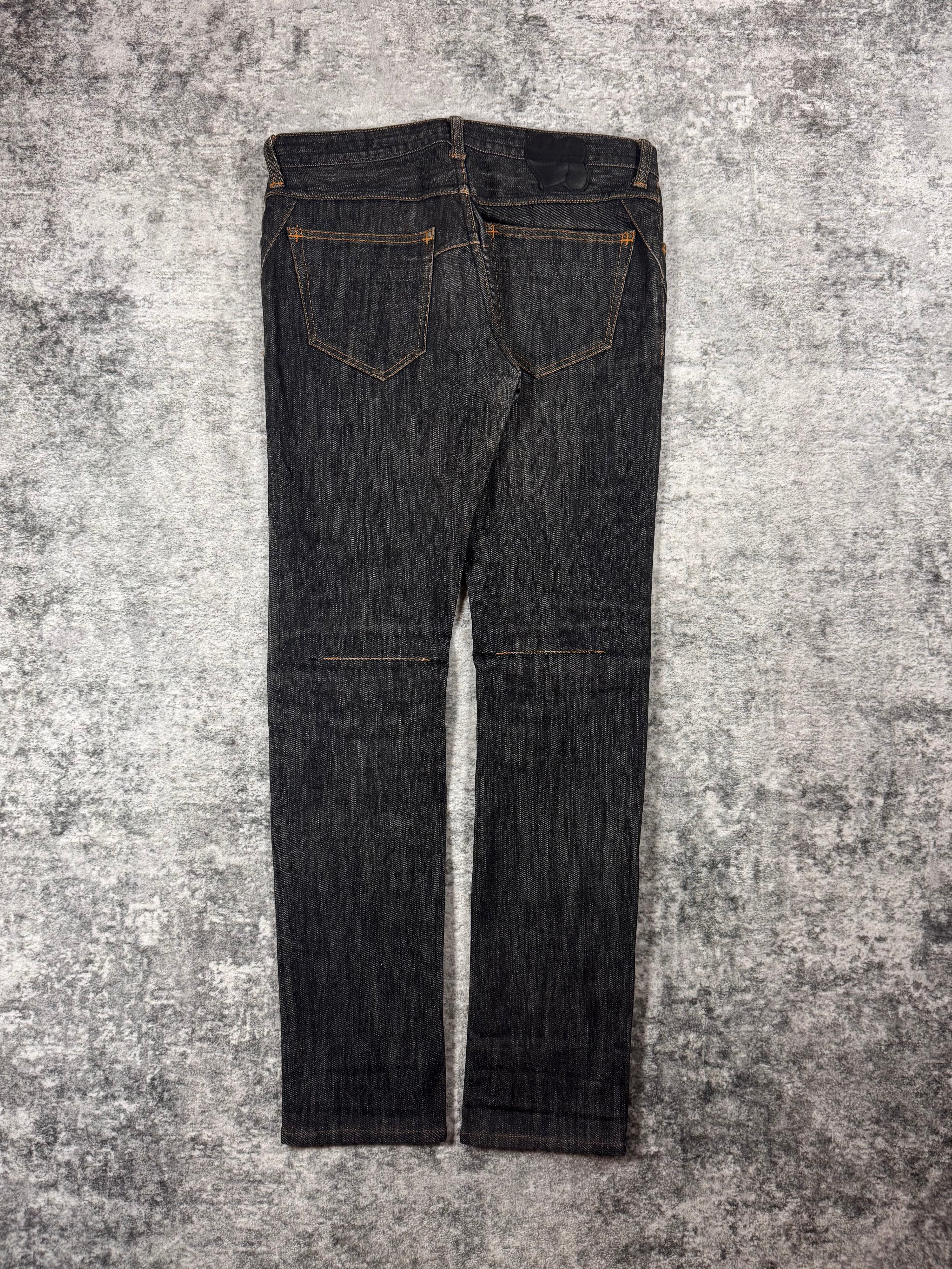 Number (N)ine raw denim from the Fall/Winter 2007 collection coming in a charcoal wash with intricate stitching details and signature crying heart patch showcased on grey background. 