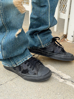 Number (N)ine mixed leather and textile heart patchwork with zigzag stitching worn on feet