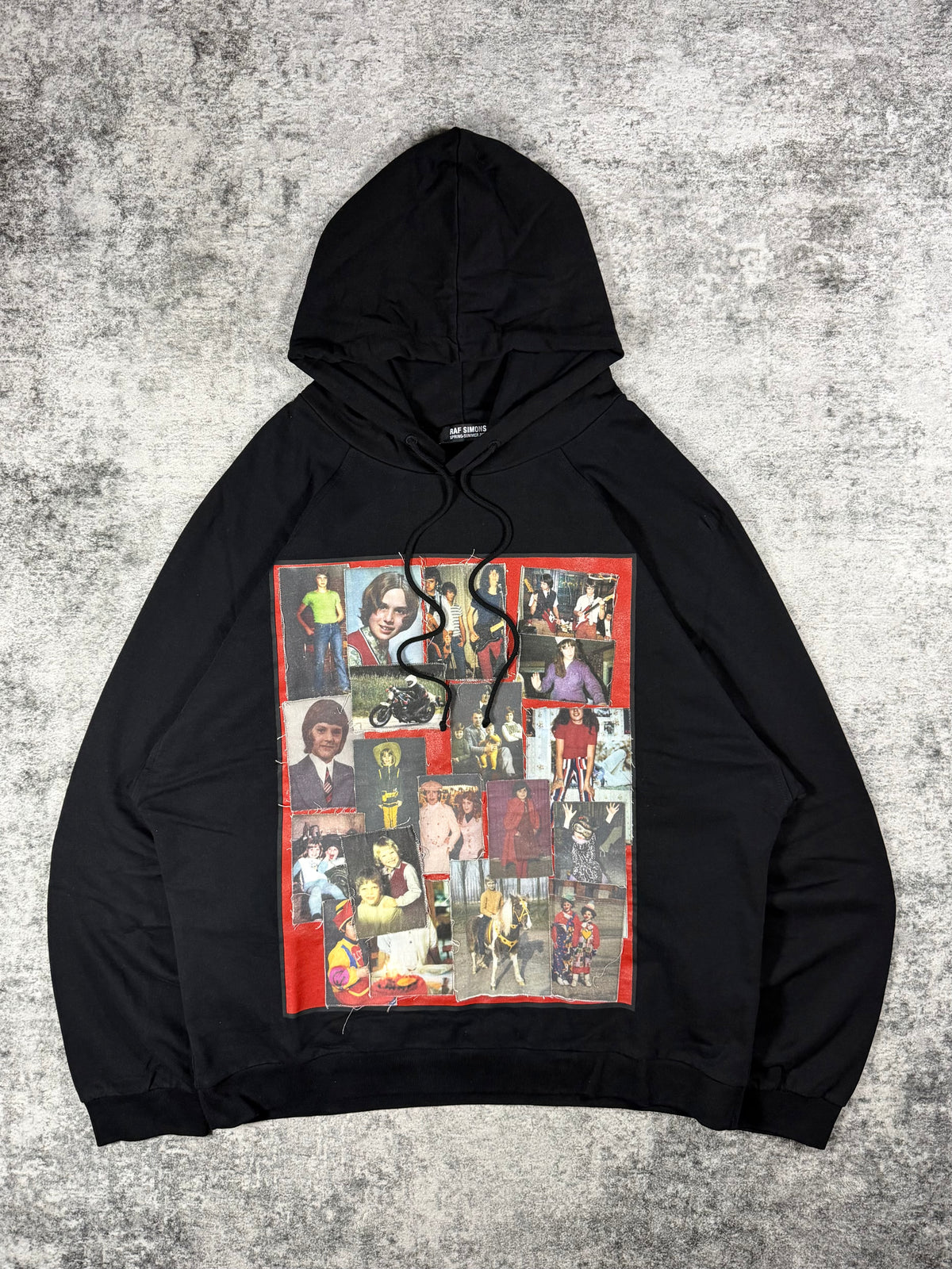 Raf Simons hoodie showcased with teenage memory portrait patchwork design as the front graphic on a black cotton hoodie with frayed details