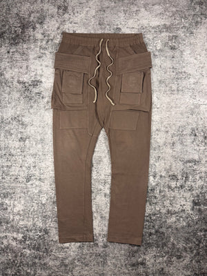 Classic Rick Owens swear pants from the Spring/Summer 2022 “Fogachine” collection. Coming in the ‘Dust’ color way, these sweatpants are in the signature ‘Creatch’ cargo silhouette